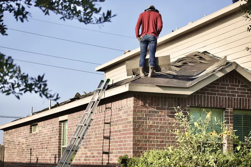 Professional roofer working on a residential roof in Edgemont